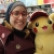 Photograph of Nada Mohammed posing with a stuffed Pikachu.